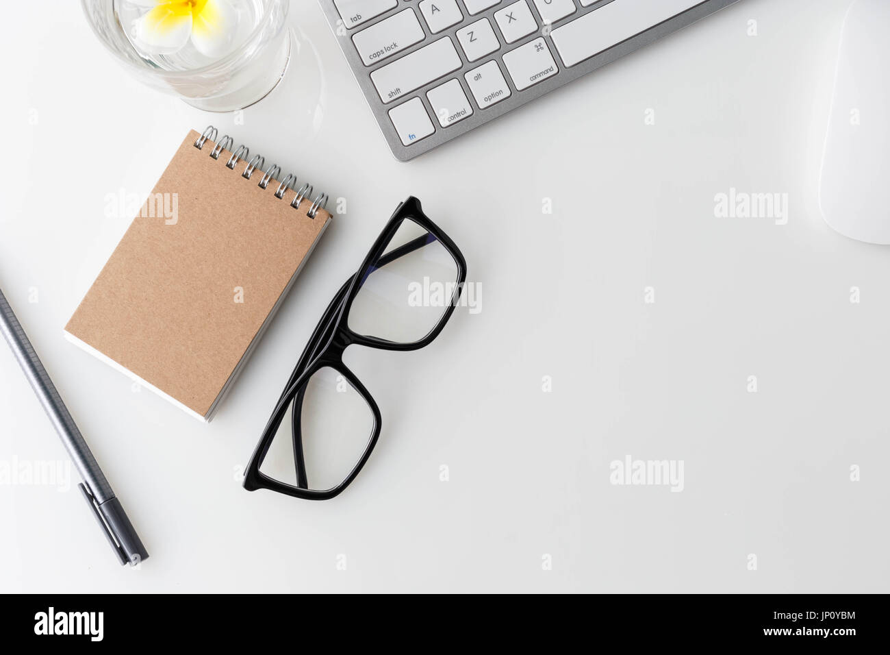 Modern white office desk top table with computer laptop, notebook and