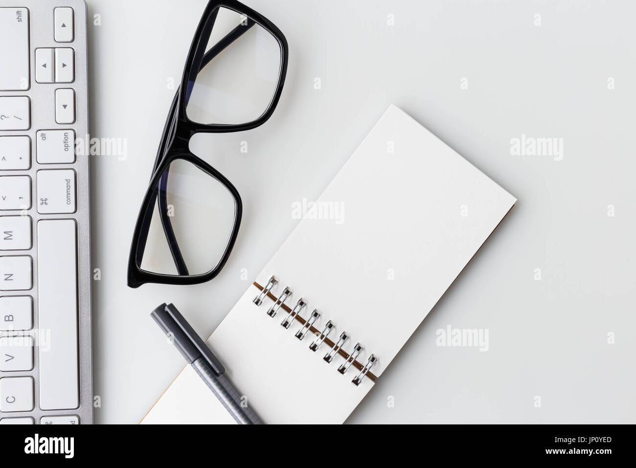 Modern white office desk top table with computer laptop, notebook and