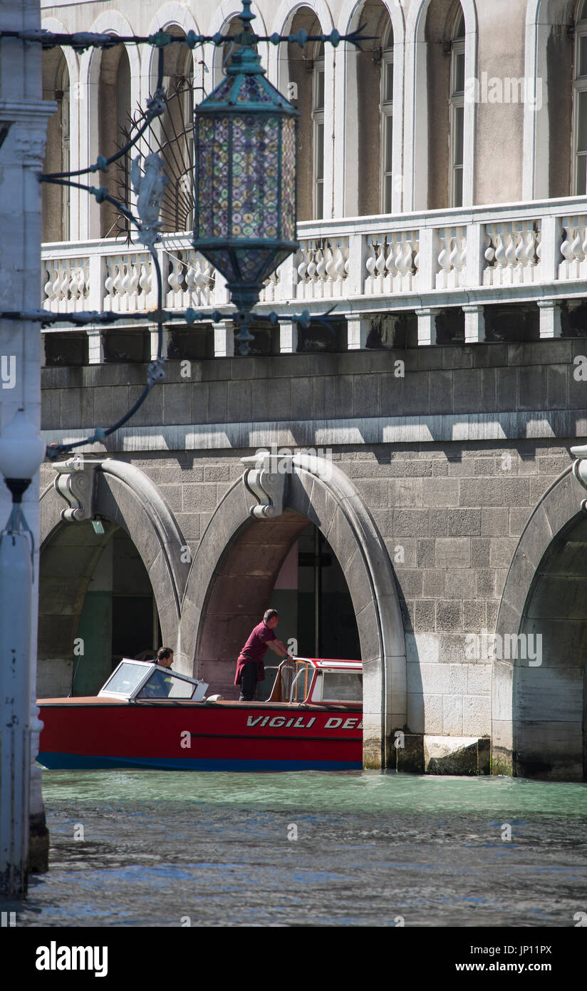 Venice, Italy - April 26, 2012: A boat from the Venice Fire Brigade pulling out of the Fire Station just off the Grand Canal in Venice. Stock Photo