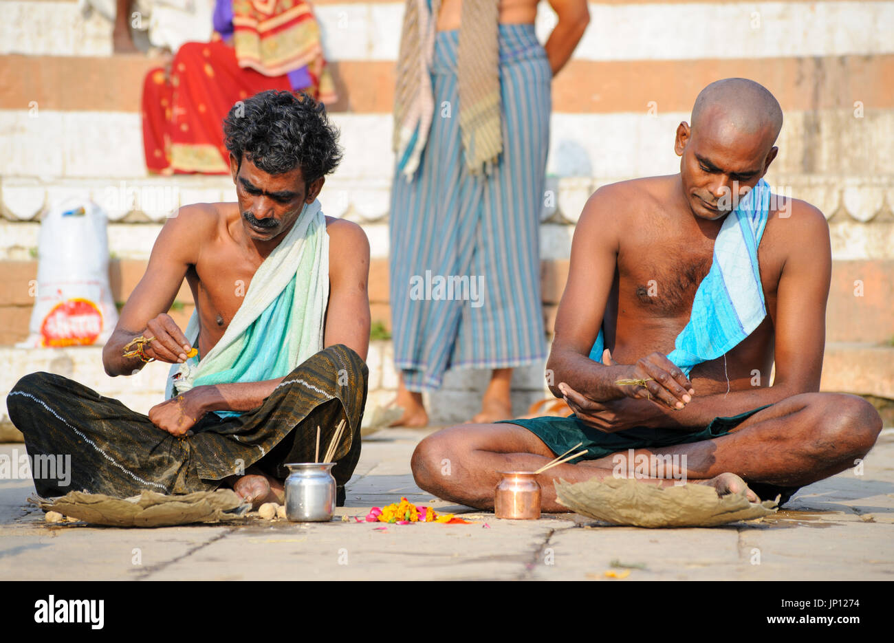 Native Powder Pray Two men sprinkle Holy Powder onto banana leaves as part of a death ...