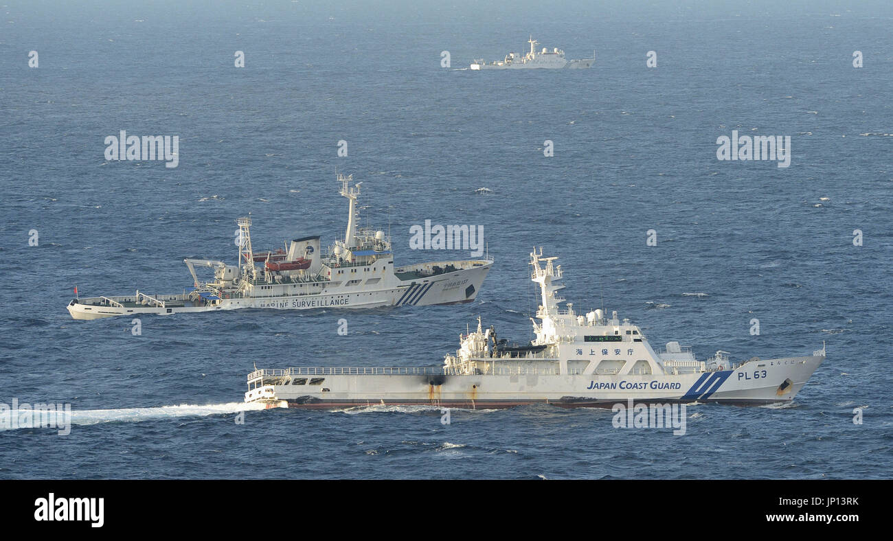 NAHA, Japan - Photo taken from a Kyodo News plane shows the Japan Coast Guard patrol vessel Yonakuni (front) and the Chinese maritime surveillance vessel Haijian 137 sailing in parallel in waters 38 kilometers north of Uotsuri Island, part of the Japan-controlled Senkaku Islands, claimed by China, in the East China Sea at 5:40 p.m. on Jan. 21, 2013. A total of three Chinese maritime surveillance vessels entered Japanese territorial waters near the Senkaku Islands earlier in the day, leading the Japanese Foreign Ministry to lodge a protest with the Chinese Embassy in Tokyo. (Kyodo) Stock Photo