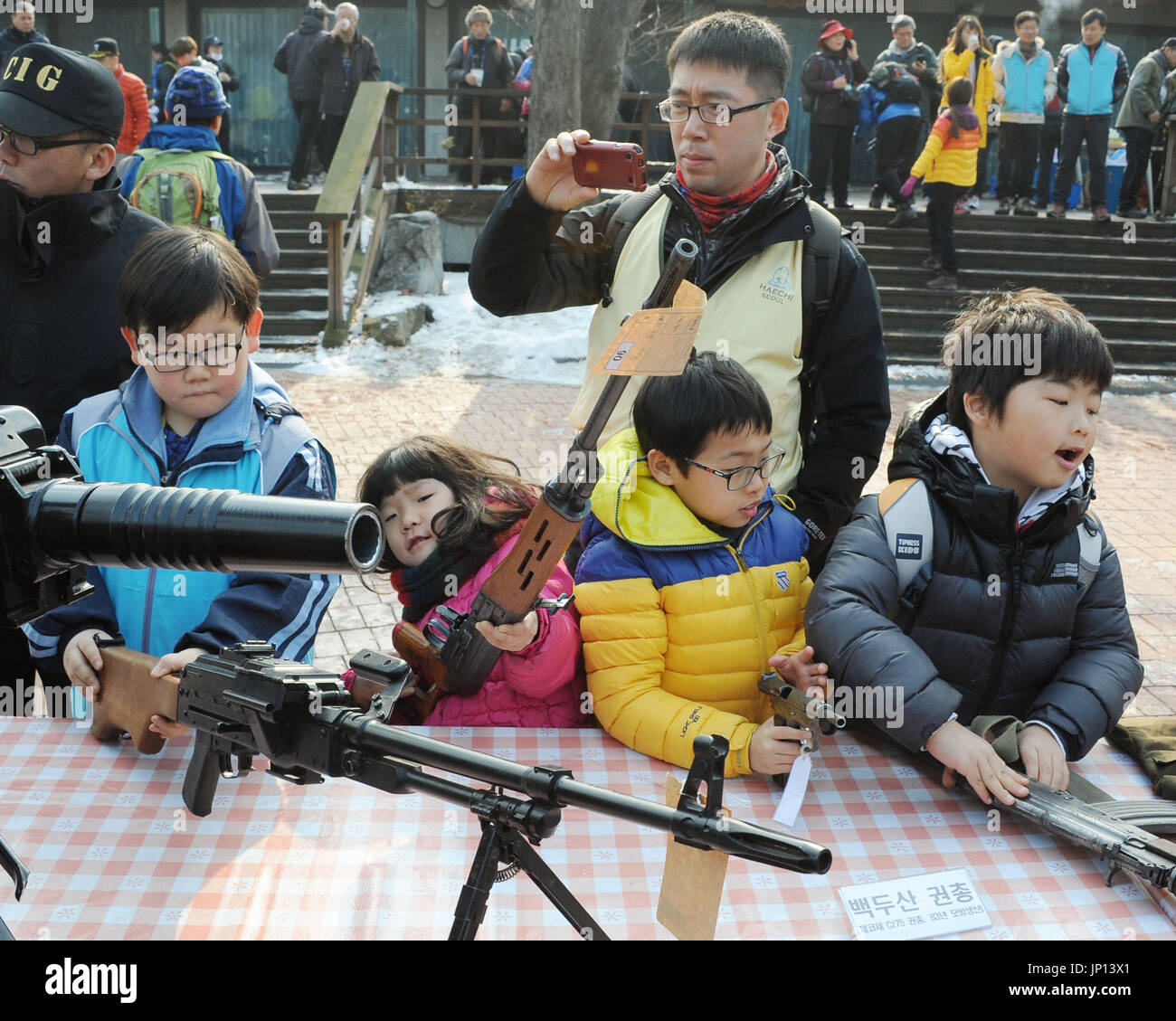 SEOUL, South Korea South Korean children touch guns that have been