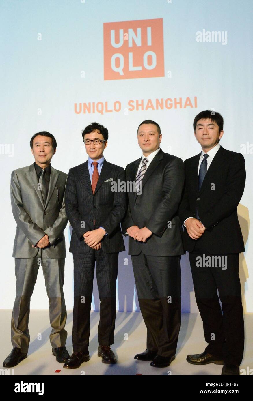 SHANGHAI, China - Senior officials of Japan's Fast Retailing Co. pose for photos during a press conference in Shanghai on Aug. 28, 2013. The company said the same day it will open Uniqlo Shanghai, the largest flagship store of the casual clothing chain in the world with a sales floor of around 8,000 square meters, on Sept. 30. (Kyodo) Stock Photo