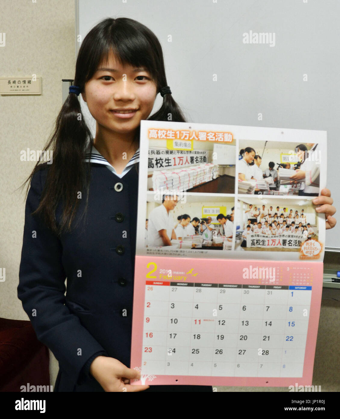 NAGASAKI, Japan - Shiori Sonoda, a high school student in Nagasaki, holds a  calendar in January 2014 that she and other students produced for sale as  part of their campaign to collect