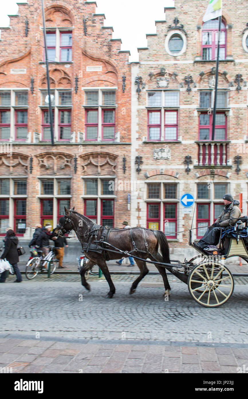 Bruges, Belgium - December 15, 2013: Horse and carriage tour of the historic section of Bruges, Belgium at Christmas time. Stock Photo