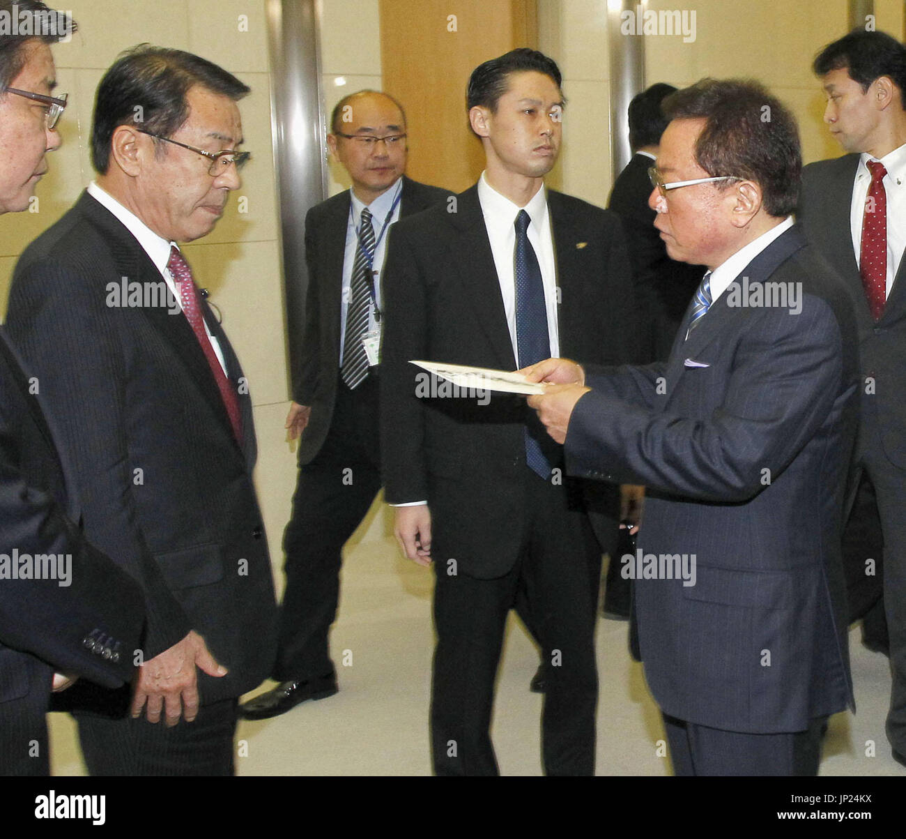 TOKYO, Japan Tokyo Gov. Naoki Inose (R) submits a letter of