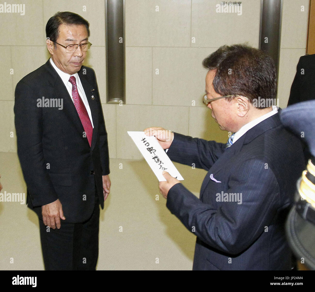 TOKYO, Japan - Tokyo Gov. Naoki Inose (R) submits a letter of ...