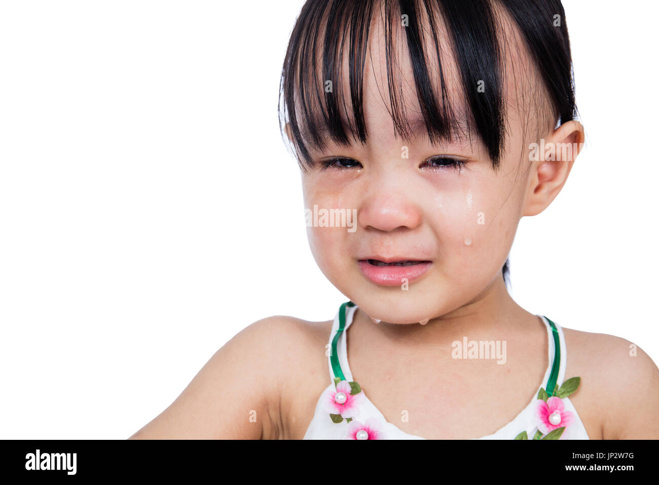 Crying Asian Chinese little girl in isolated white background Stock Photo