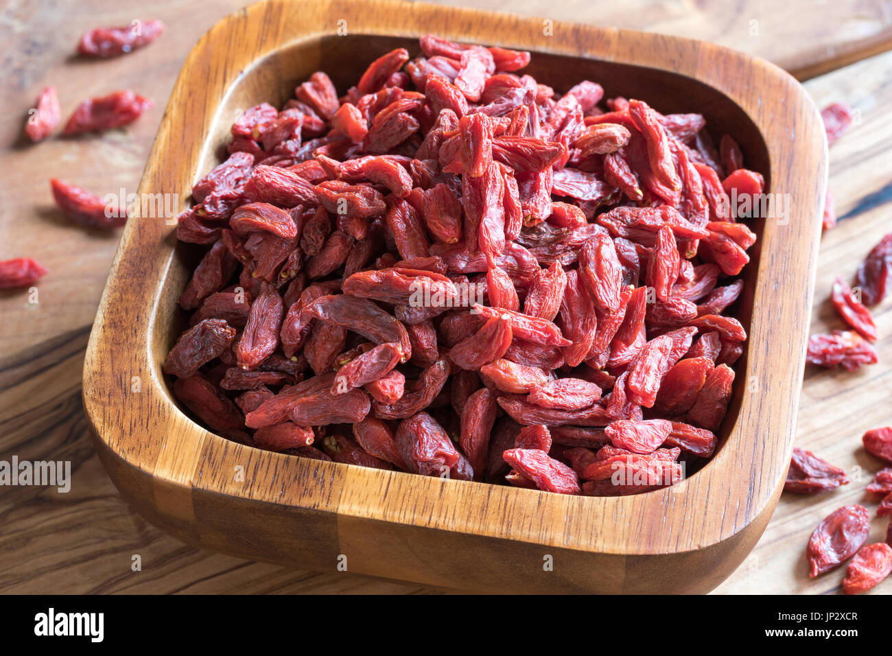 Dried goji berries in a wooden bowl Stock Photo