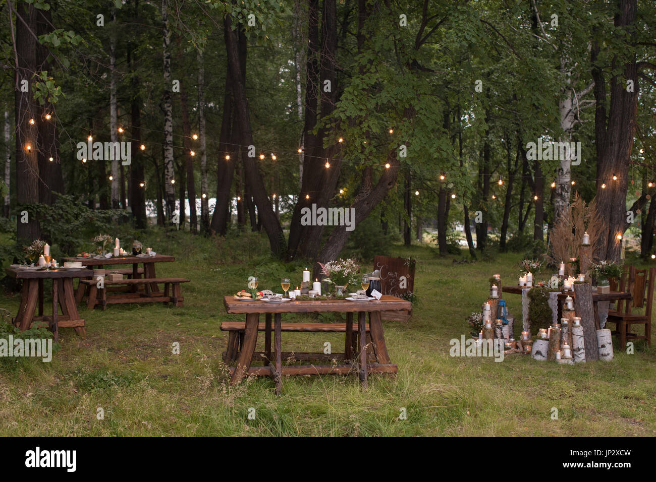 Tables set in forest Stock Photo Alamy