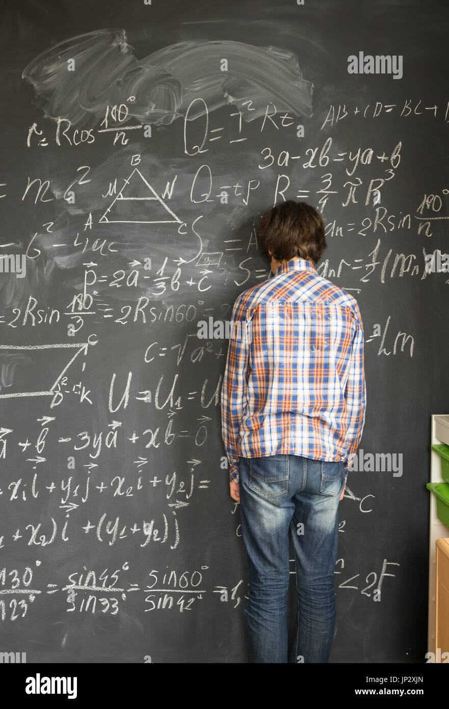 Boy writting on black board Stock Photo