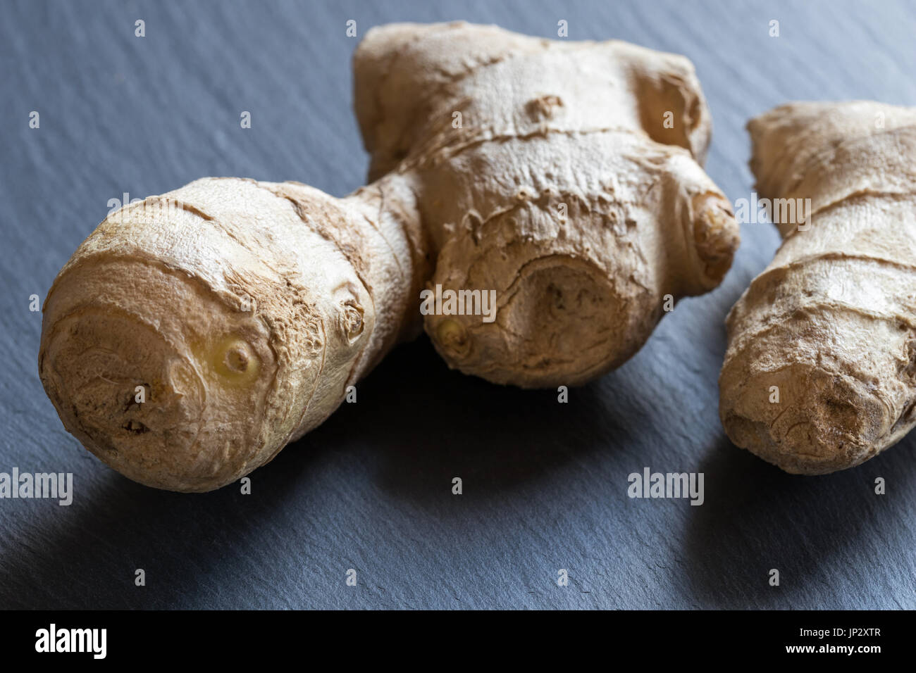Fresh ginger root on a dark background Stock Photo