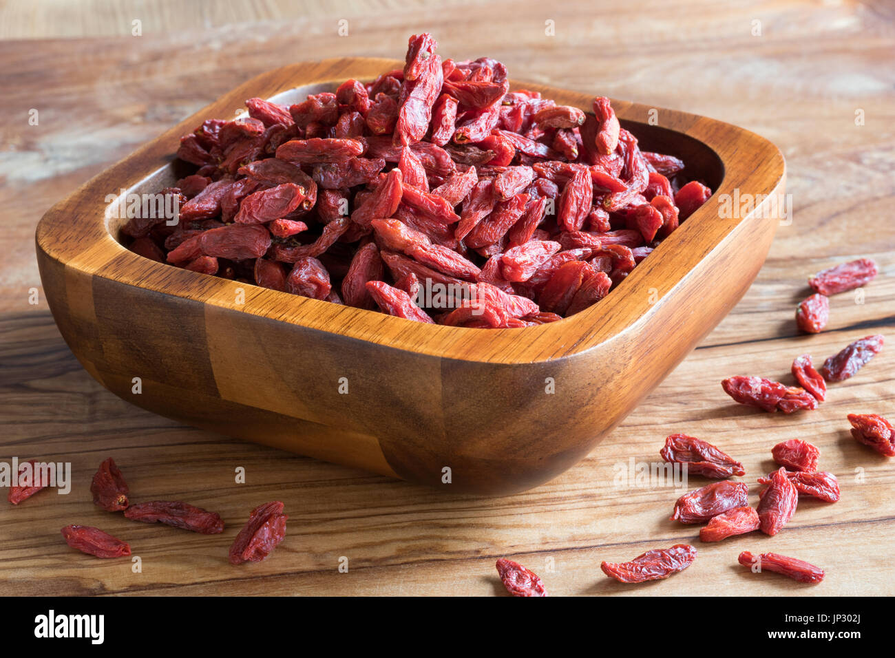 Dried goji berries in a wooden bowl Stock Photo