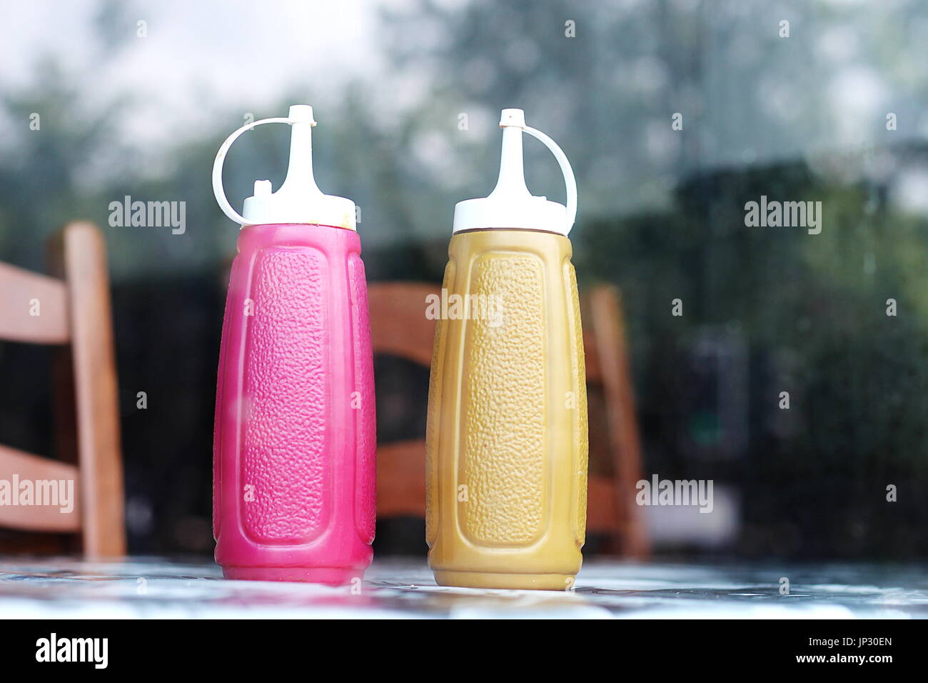 Ketchup and mustard in cafe window Stock Photo