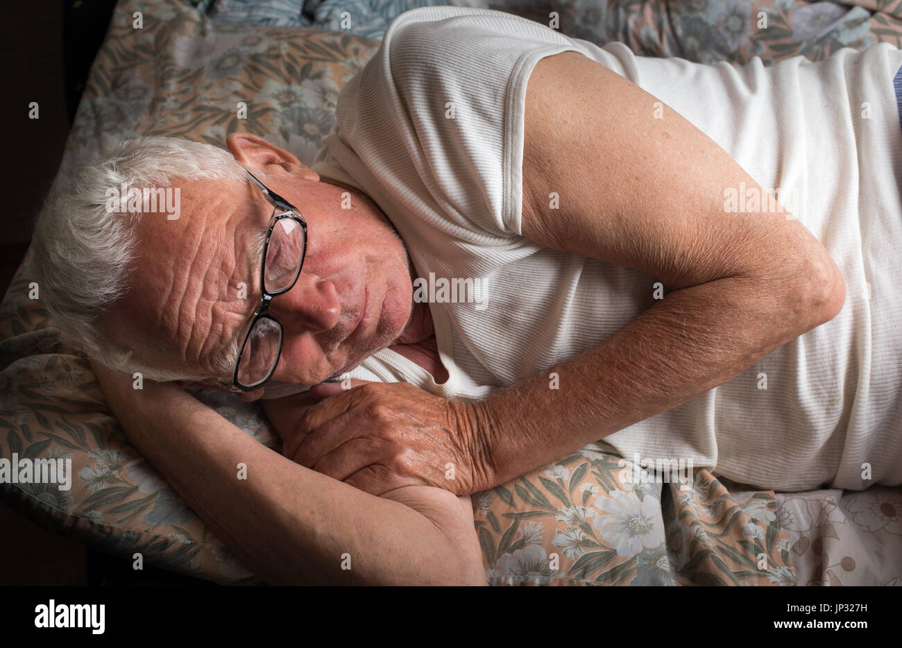 Old man lying in bed hi-res stock photography and images - Alamy