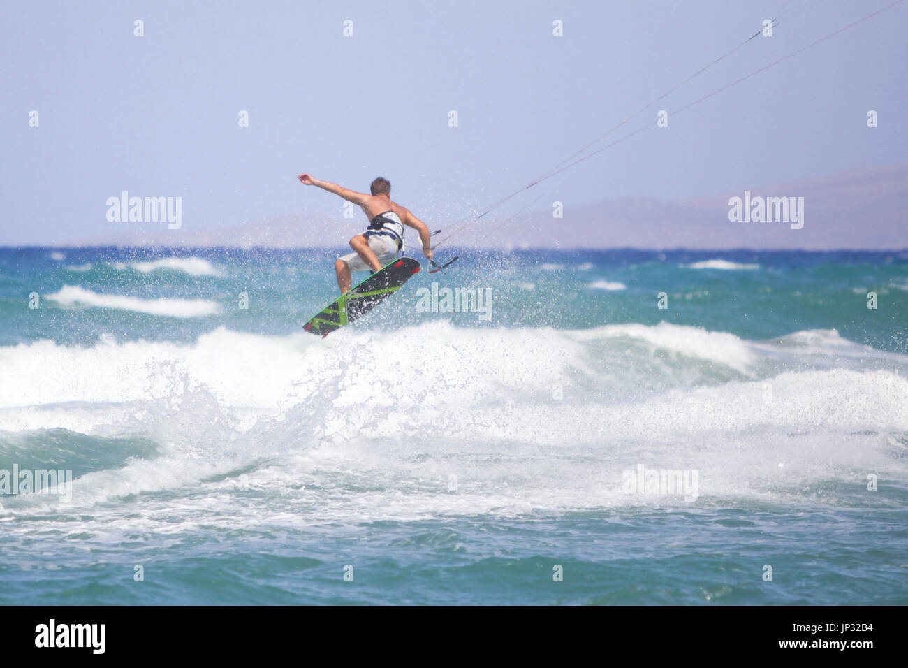 Europe, Greece, Kreta - a kitesurfer jumping in the waves Stock Photo