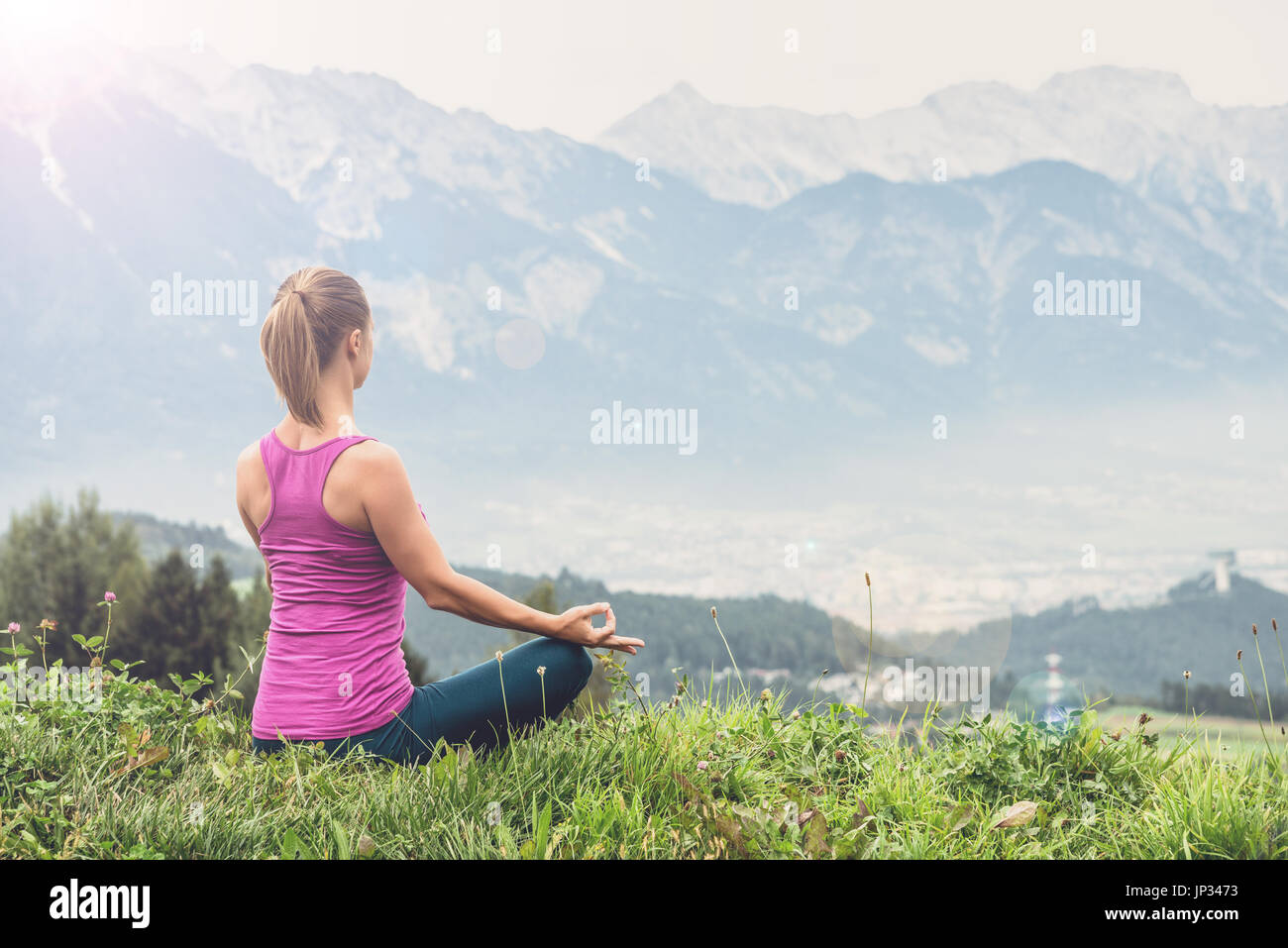 young woman on top of the mountain meditate Stock Photo - Alamy
