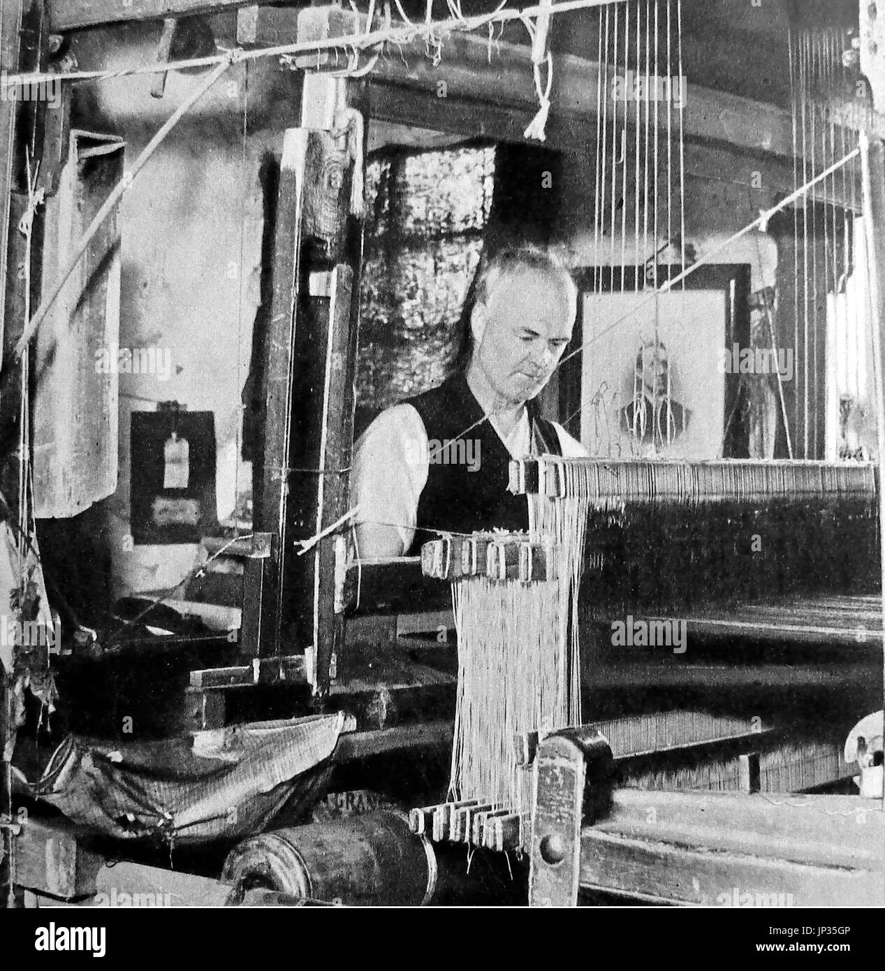 A Scottish kilt weaver working from home at Kilbarchan  circa 1932 Stock Photo
