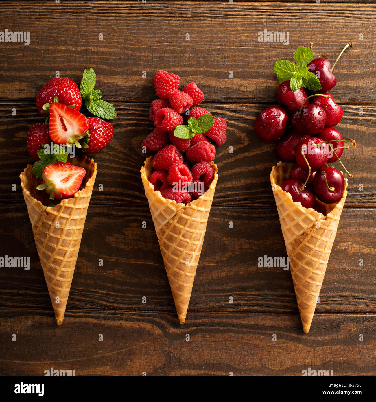 Fresh fruit and berries in waffle cones Stock Photo