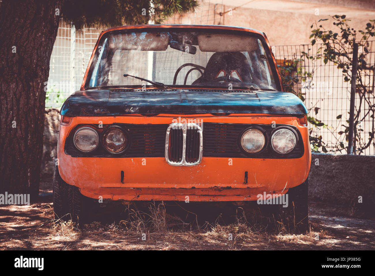 Old forgotten rustc car. Front view. Vintage filter Stock Photo