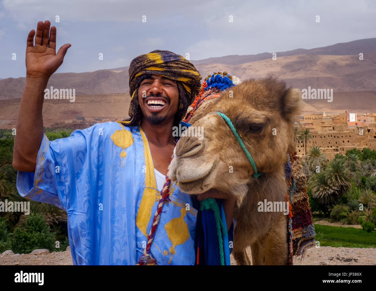 A berber man smiling with his camel in Todra valley ,Morocco Stock Photo