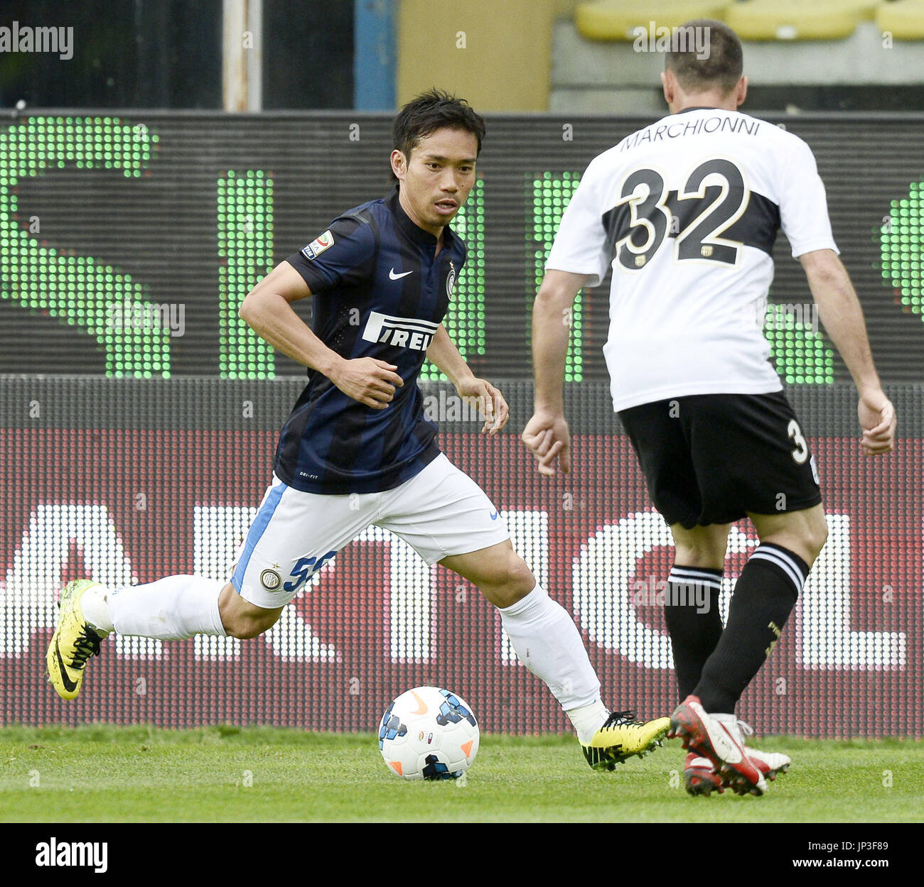 PARMA, Italy - Inter Milan's Yuto Nagatomo (L) attempts to get inside against Parma's Marco Marchionni in the first half of an Italian Serie A soccer match against Parma on April 19, 2014, in Parma, Italy. Inter won 2-0. (Kyodo) Stock Photo