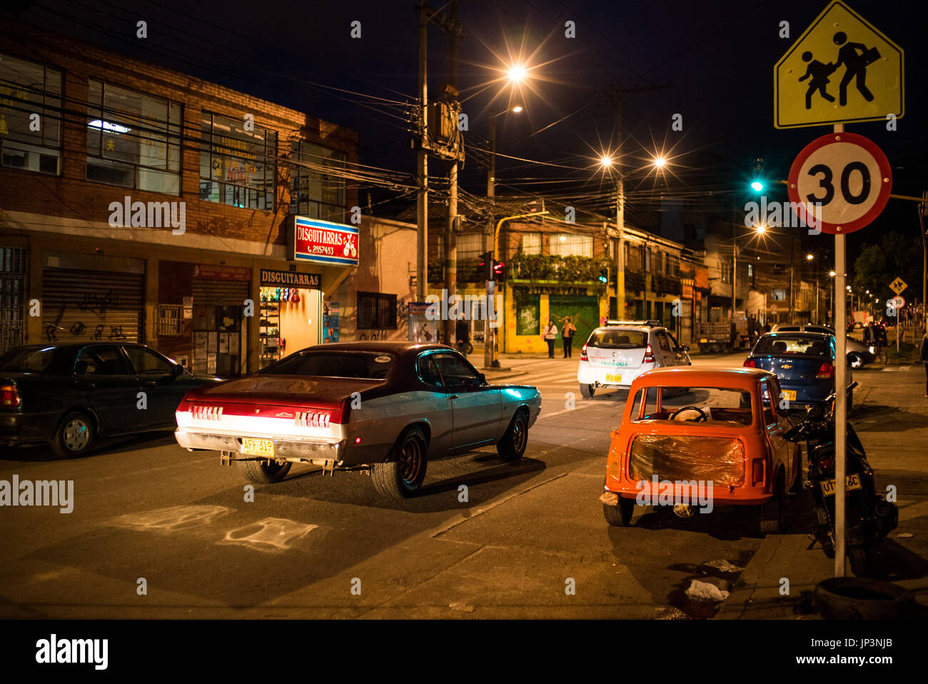 a 1972 Dodge Demon idles at the traffic lights in a suburban street in Bogota, Colombia. American classic cars are well collected in Colombia Stock Photo