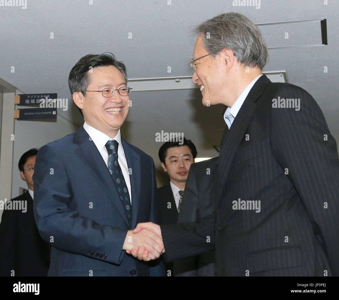 TOKYO, Japan - Hwang Joon Kook (L), South Korea's special representative for Korean Peninsula peace and security affairs, and Junichi Ihara, director general of the Asian and Oceanian Affairs Bureau at the Japanese Foreign Ministry, shake hands at the Foreign Ministry in Tokyo on July 16, 2014, prior to their talks. They agreed to strengthen bilateral and trilateral coordination with the United States on reining in North Korea's missile and nuclear weapons programs. (Pool photo by Jiji Press)(Kyodo) Stock Photo