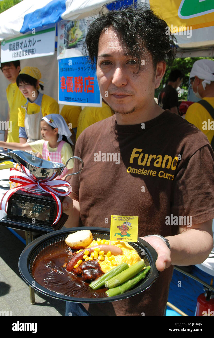 YOKOSUKA, Japan A food vendor holds an omelet curry from Furano in
