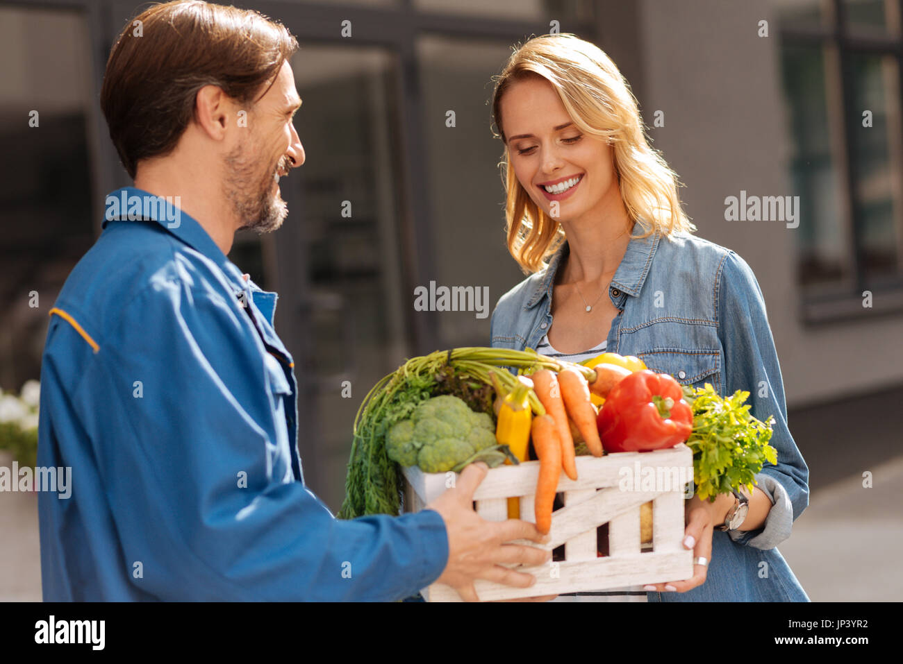 Cheerful friendly woman picking up her groceries Stock Photo Alamy