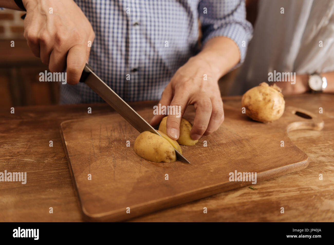 Inspired passionate man chopping potato Stock Photo Alamy