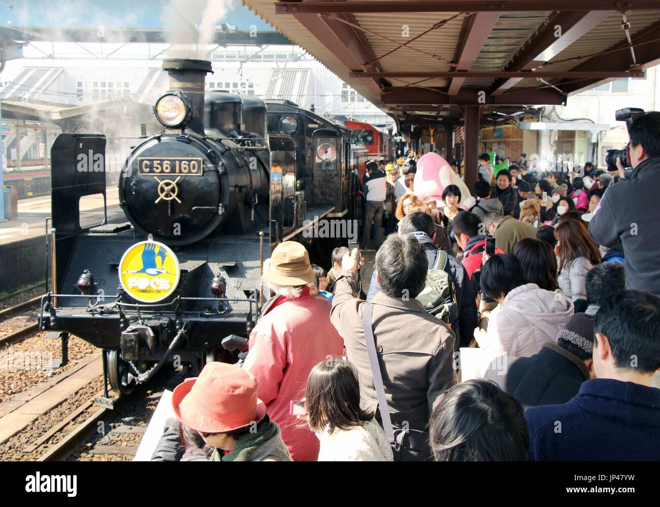 YAMAGUCHI, Japan - The steam locomotive 'SL Yamaguchi' resumes roundtrip service between Shin-Yamaguchi and Jifuku stations on the JR Yamaguchi Line in Yamaguchi Prefecture on March 21, 2014. The train had operated service only one way between these stations from November 2013 after services on the line were partially suspended due to torrential rain damage sustained in July 2013. (Kyodo) Stock Photo