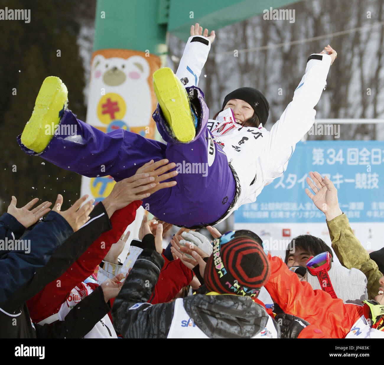 HAKUBA, Japan - Fellow Japanese skiers toss Aiko Uemura after she won her eighth moguls title at the freestyle skiing national championships in her last competitive appearance in Hakuba, Nagano Prefecture, on March 27, 2014. Uemura, a five-time Olympian, won the overall World Cup crown in the 2007-2008 season and two titles at the 2009 world freestyle championships. (Kyodo) Stock Photo