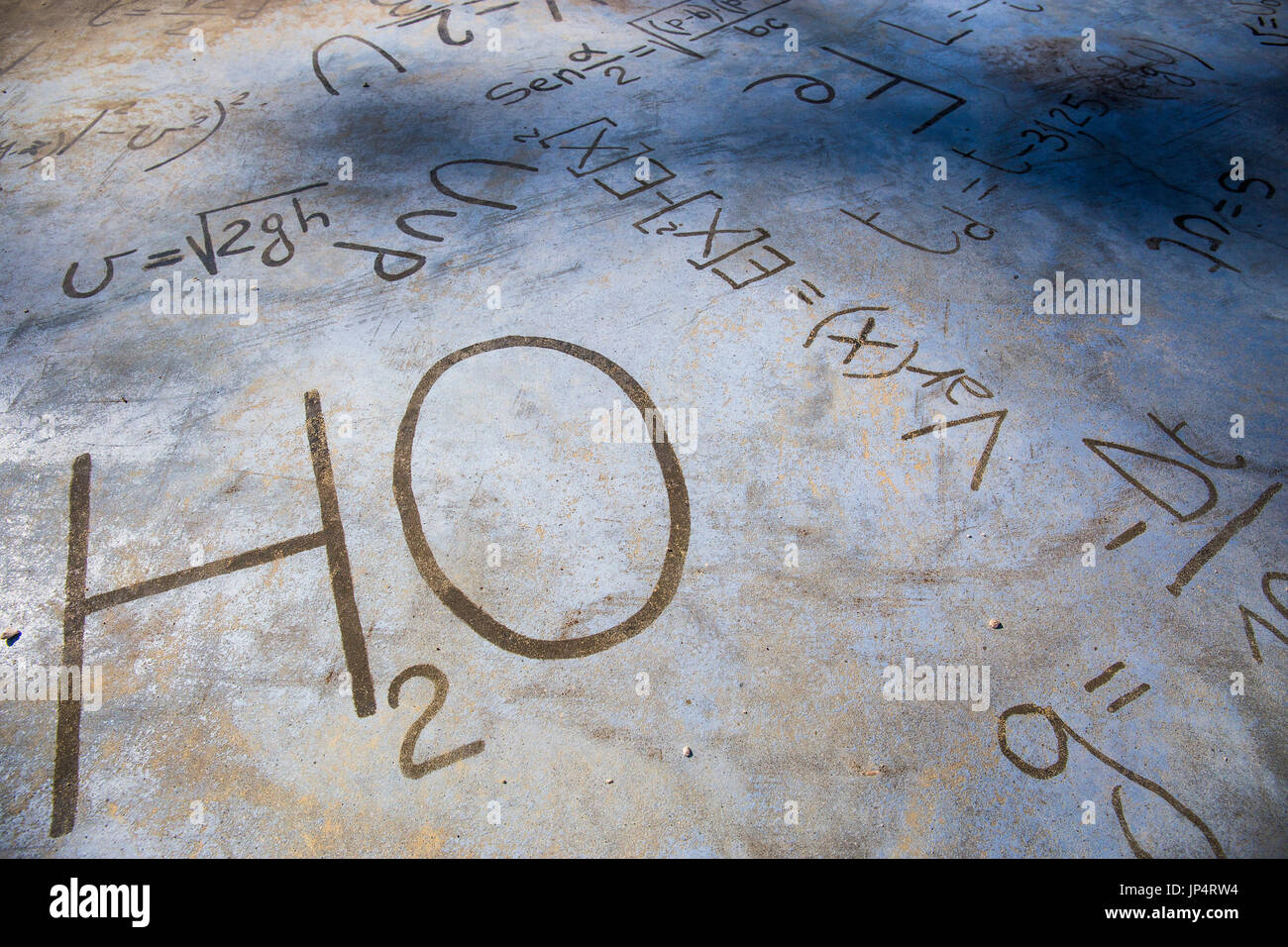 Chemical equations on a stone pavement. H2O. Stock Photo