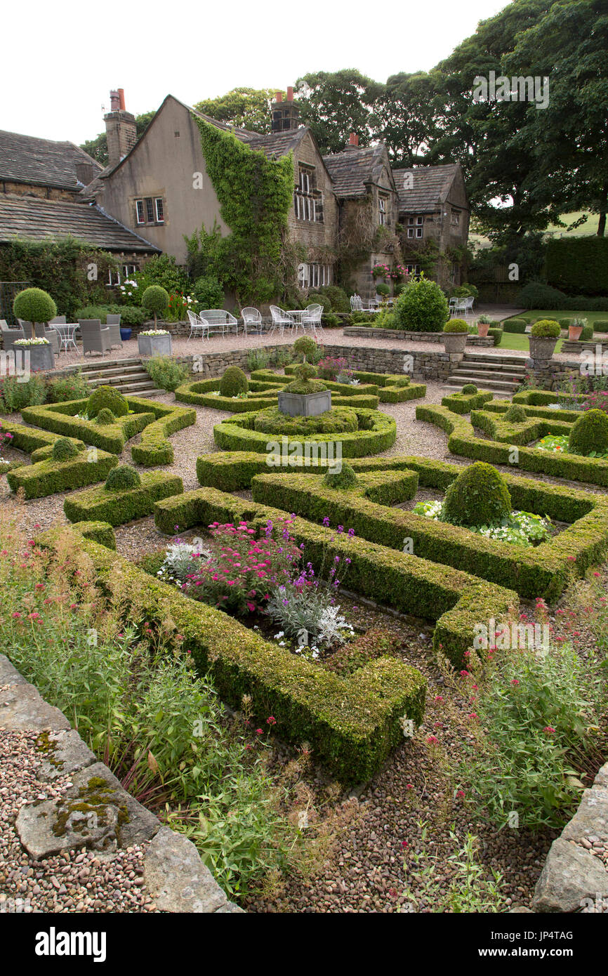 Sunken garden and the facade of the Holdsworth House hotel and restaurant in Halifax, England. The Jacobean Manor holds a four star hotel. Stock Photo