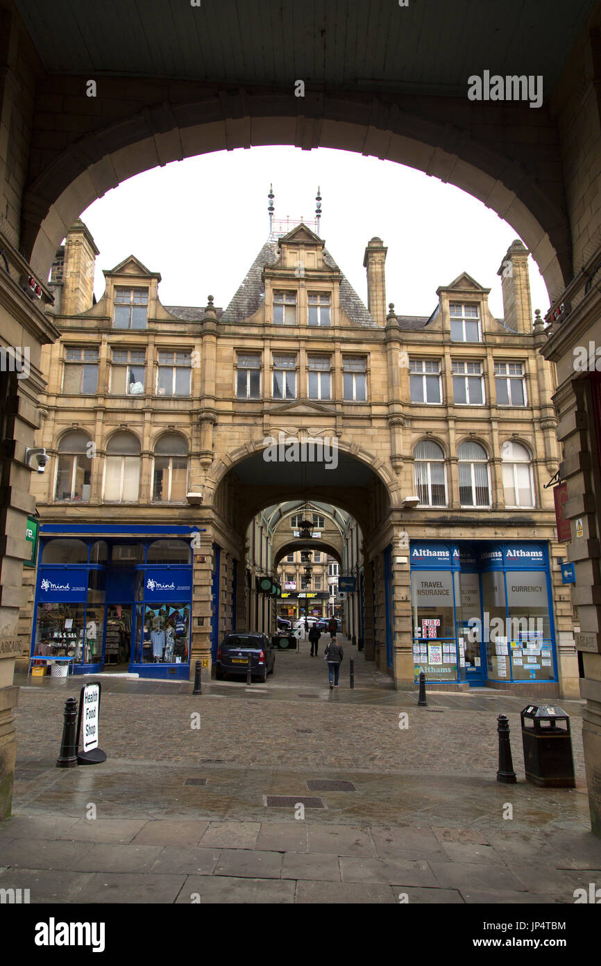 Victorian architecture in Halifax, England. A stone facade is viewed through the archway of a passage. Stock Photo