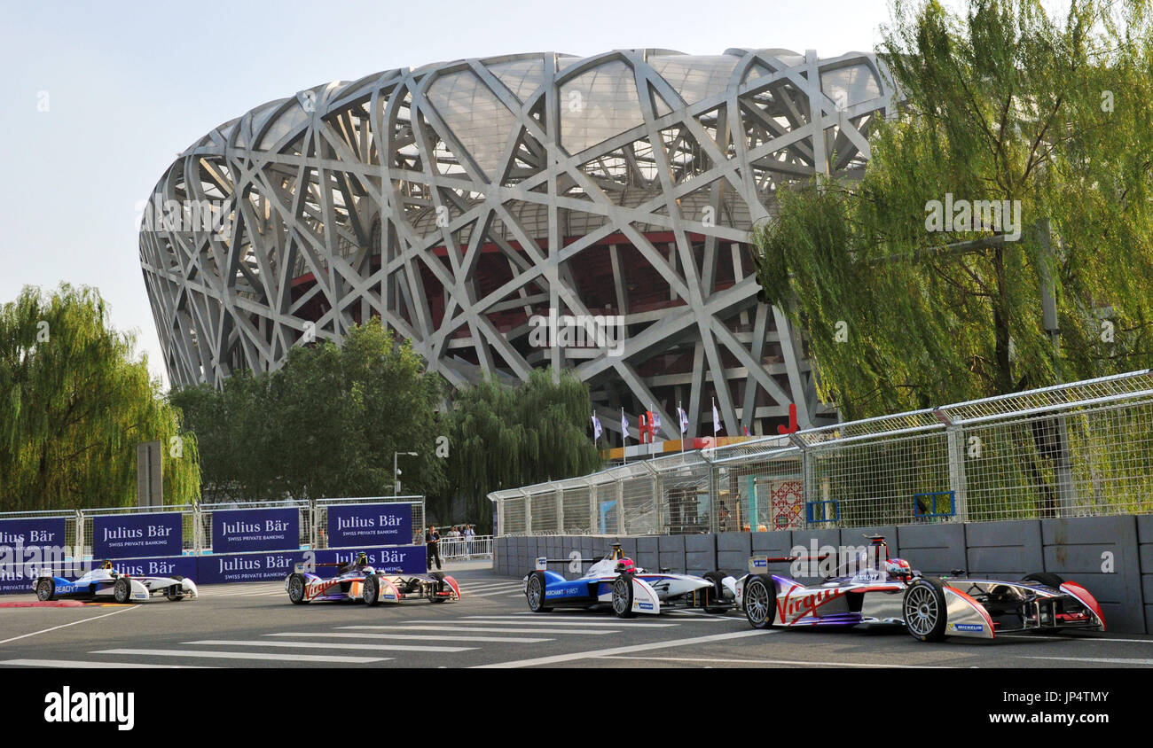 BEIJING, China - Racing cars hum past the Bird's Nest National Stadium ...