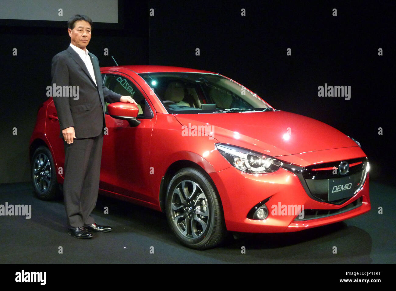 TOKYO, Japan - Mazda Motor Corp. CEO Masamichi Kogai stands beside the ...