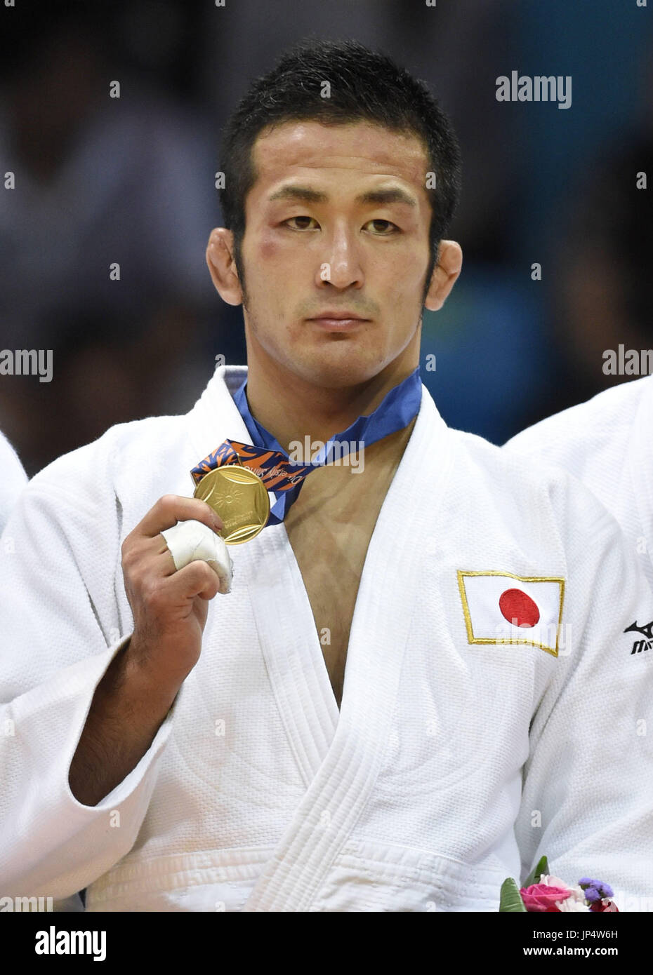 INCHEON, South Korea Hiroyuki Akimoto of Japan holds up the gold medal during an award
