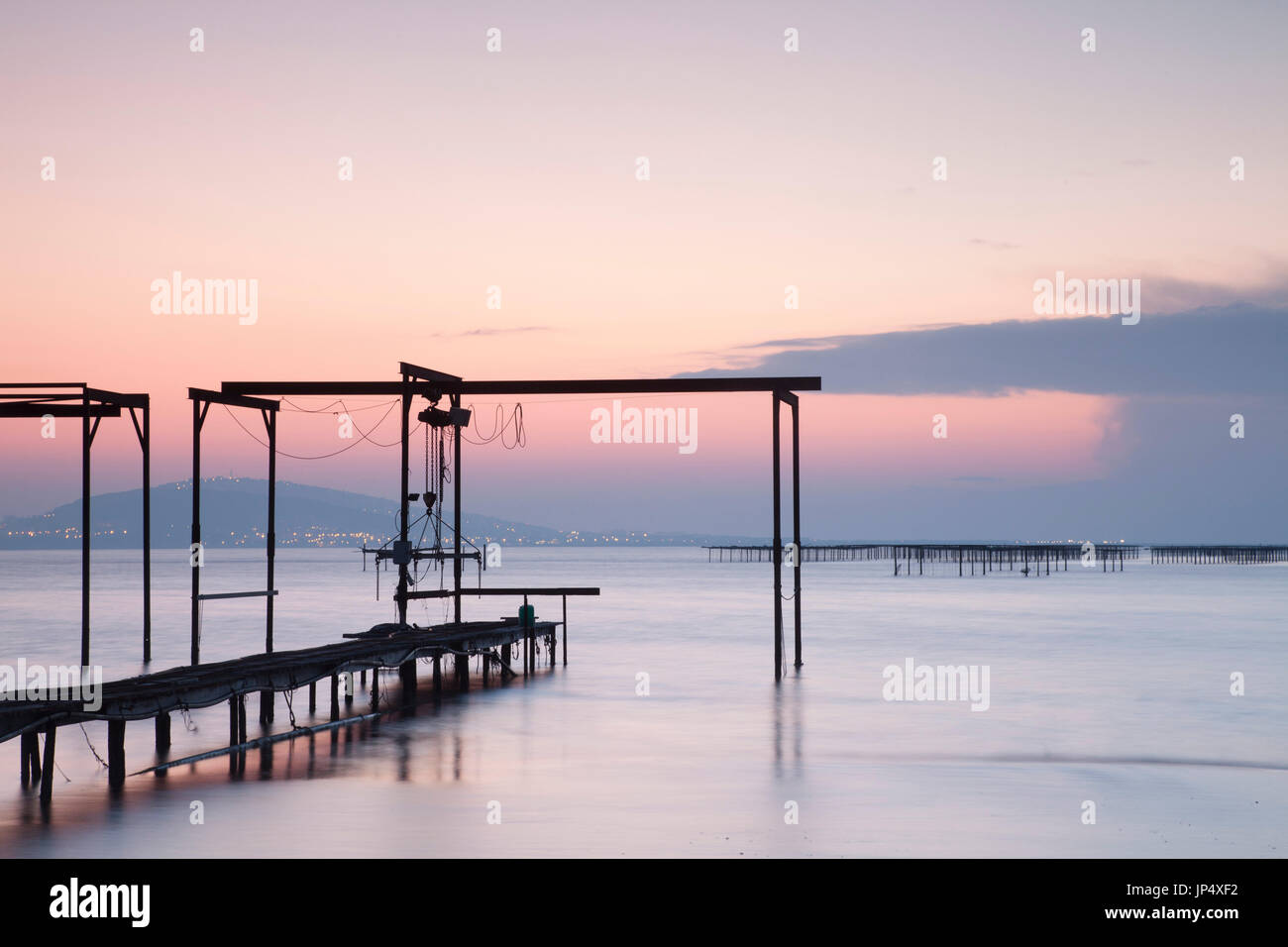 Wooden fishing pier, Etang de Thau, southwest France, at dawn. Stock Photo