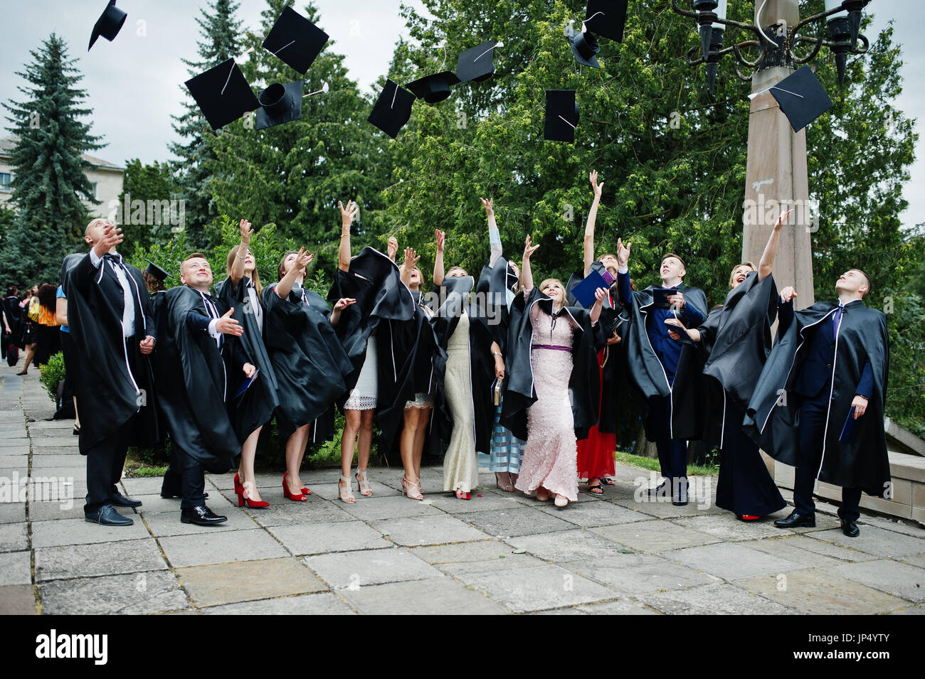 Happy university graduates throwing their graduation caps into the air