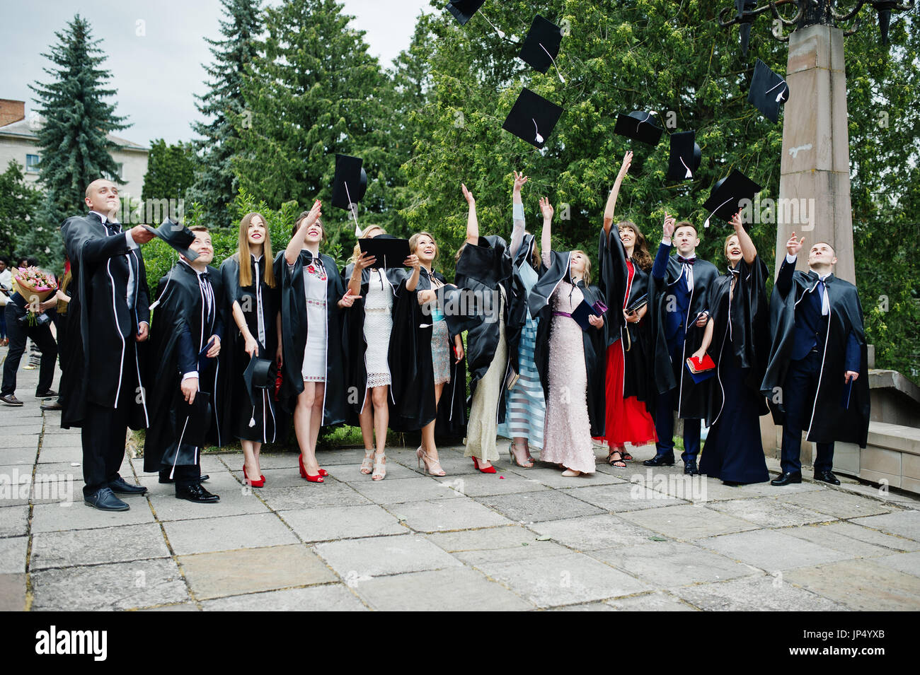 Happy university graduates throwing their graduation caps into the air