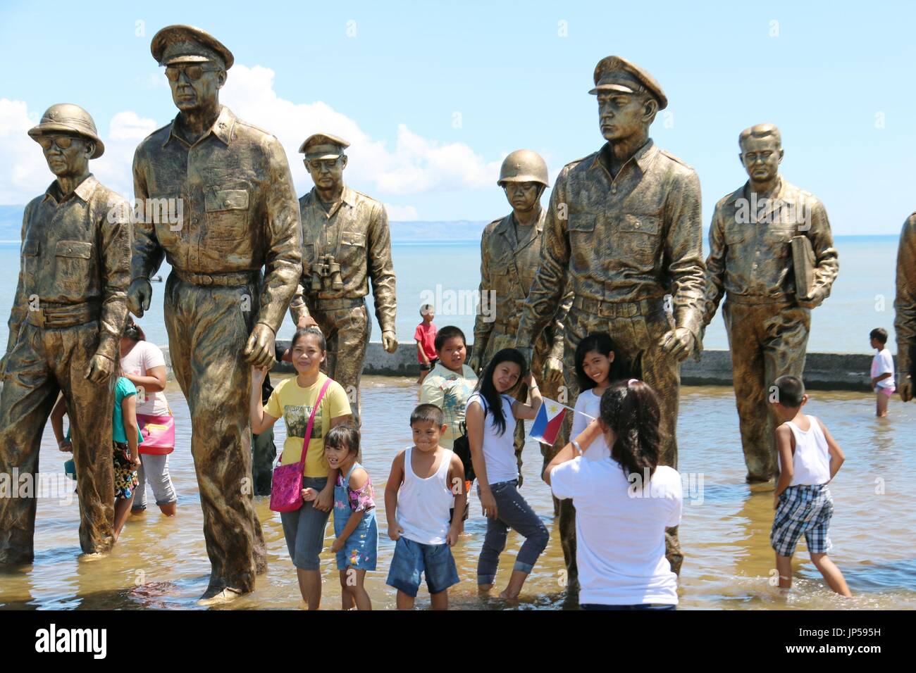 PALO, Philippines Filipinos take pictures on Oct. 20, 2014, in front of the bronze statues of