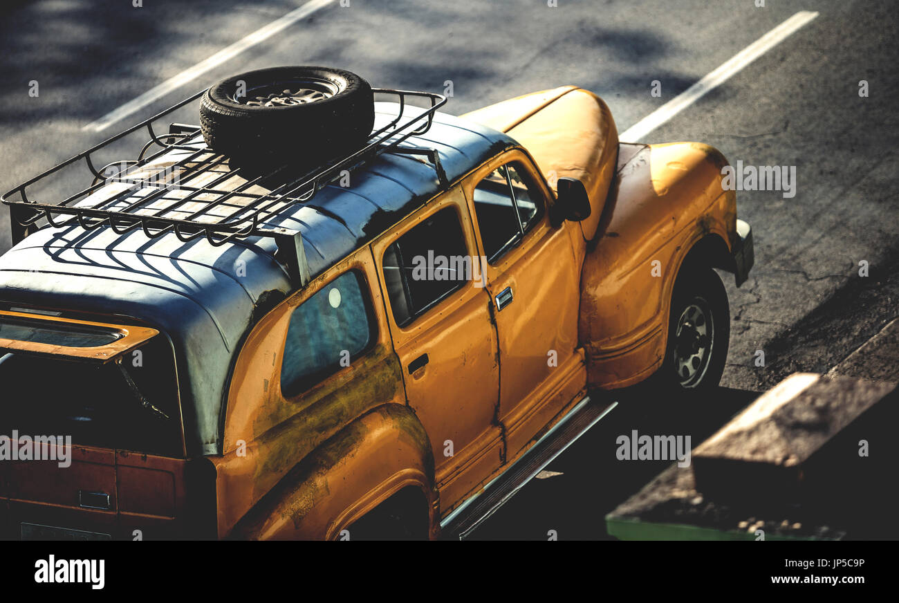 High Angle Shot Of A Classic 1950s Car With A Tyre On A Roof Rack Driving On A Road Stock Photo Alamy