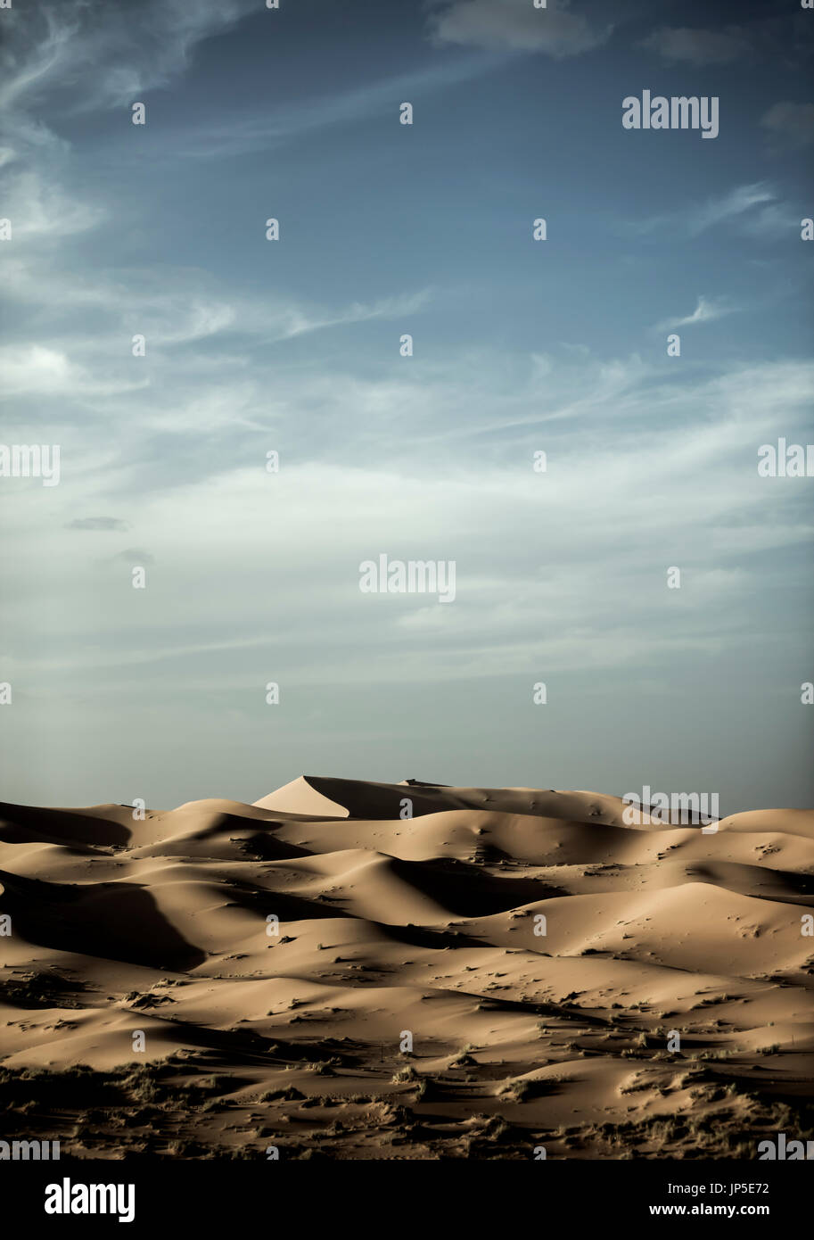 Desert landscape with sand dunes under a cloudy sky Stock Photo - Alamy
