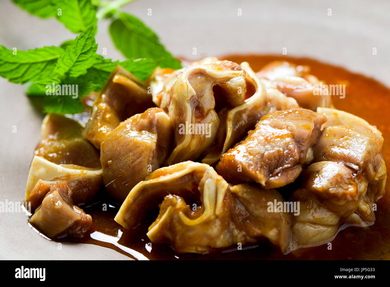 spanish oreja de cerdo, a typical stew of pigs ear, served on a slate tray Stock Photo