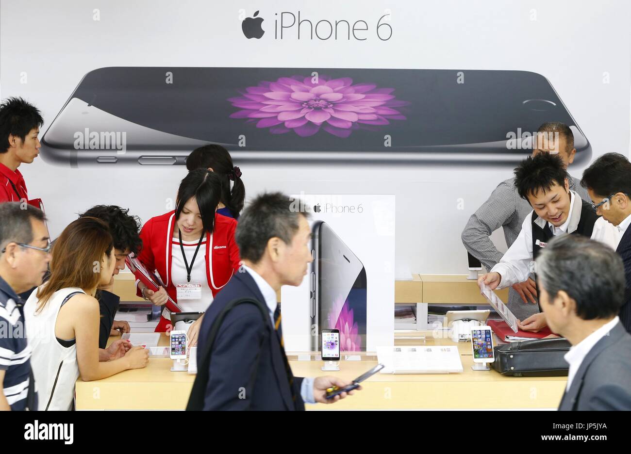 TOKYO, Japan - Shoppers flock to the sales floor for new iPhones of Apple Inc. at the Bic Camera Yurakucho store in Tokyo on Sept. 26, 2014. (Kyodo) Stock Photo