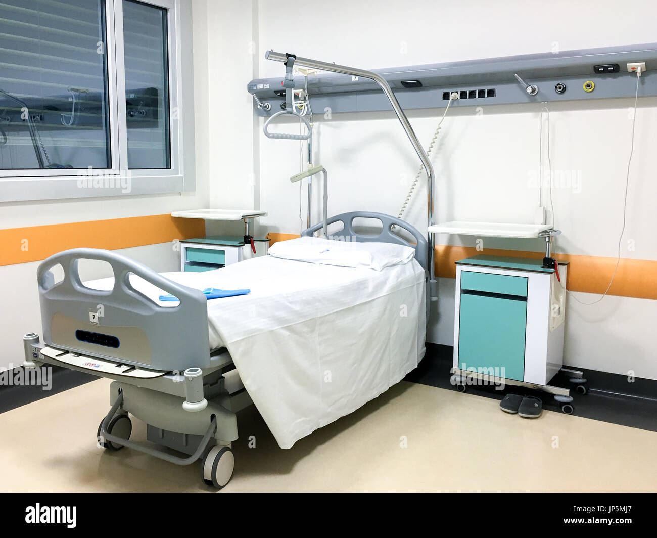 Interior of hospital room with single bed and medical equipments. Stock Photo