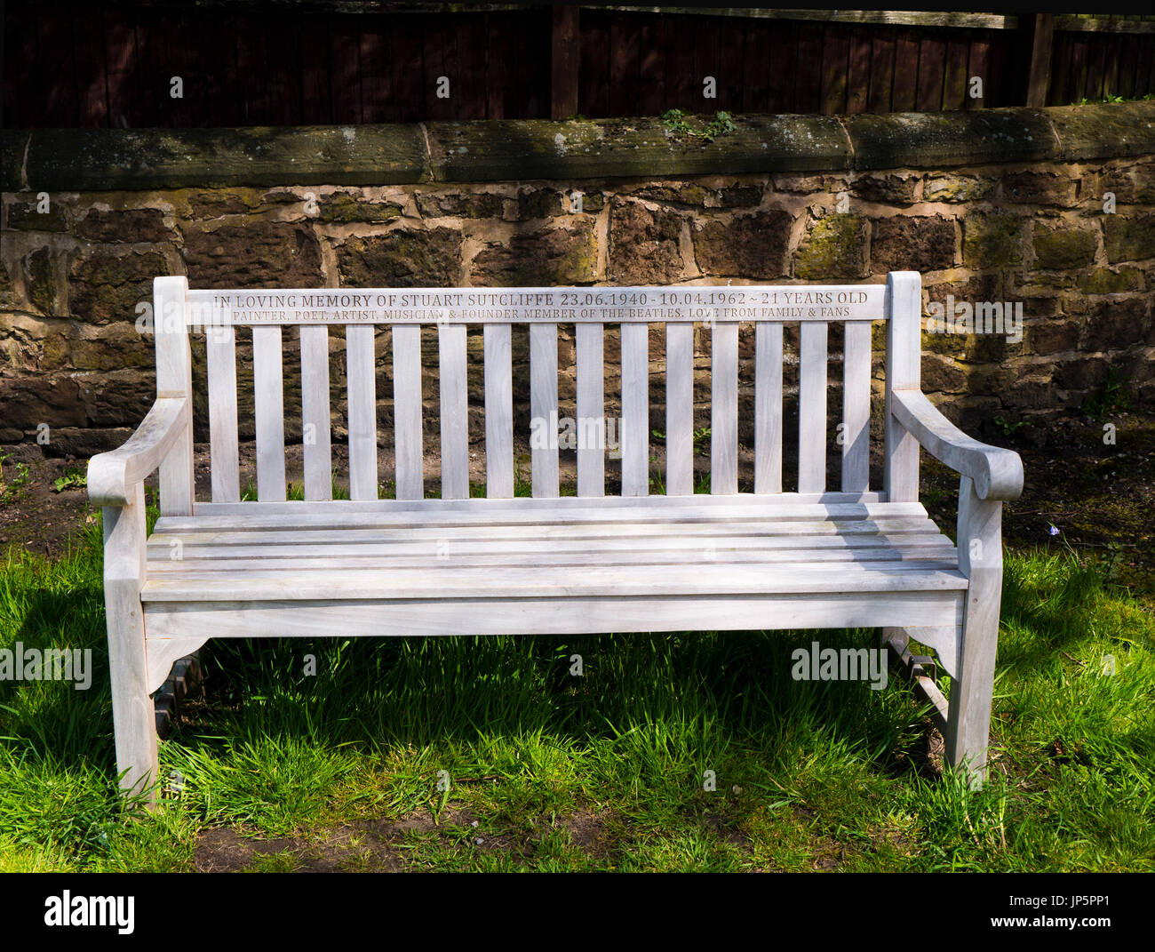 Memorial bench to former Beatle, Stuart Sutcliffe at Huyton Parish Church, Bluebell Lane Huyton, Liverpool. Stock Photo