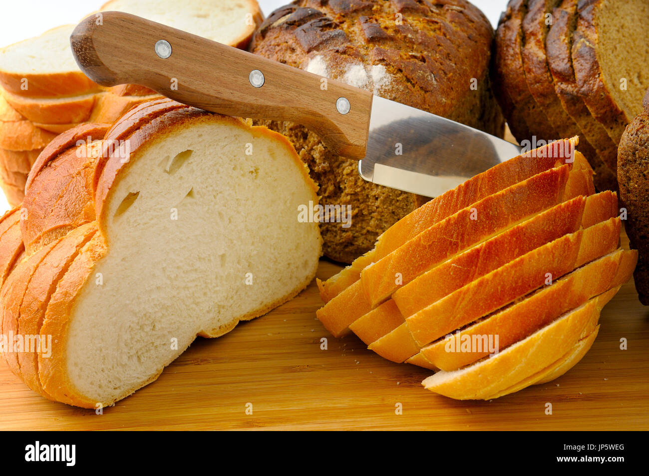 cut bread and knife isolated on white Stock Photo
